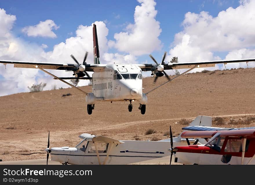 Airplane with propellers landing on a desert airport. Airplane with propellers landing on a desert airport