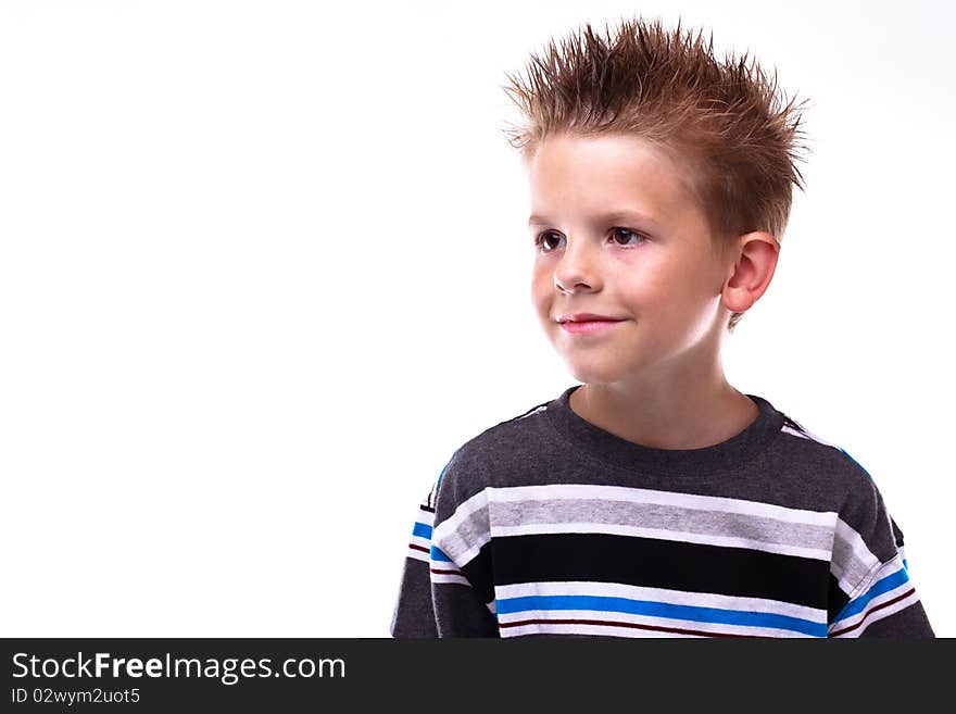 Cute little boy smiling and looking away from the viewer on a white background. Cute little boy smiling and looking away from the viewer on a white background