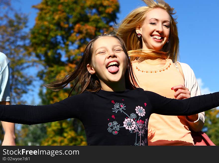 Two Happy Sisters Have Fun In Park