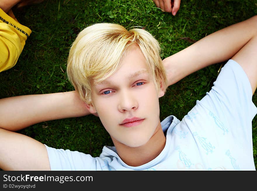 Young and attractive teenager get rest at grass