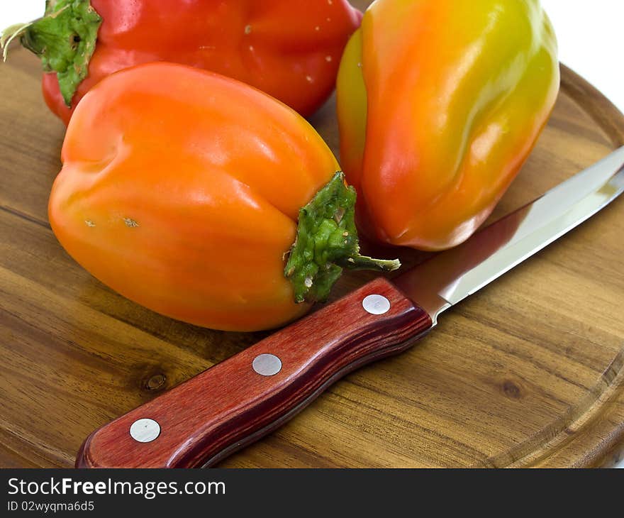 Colorful Paprikas On Wooden Kitchen Board