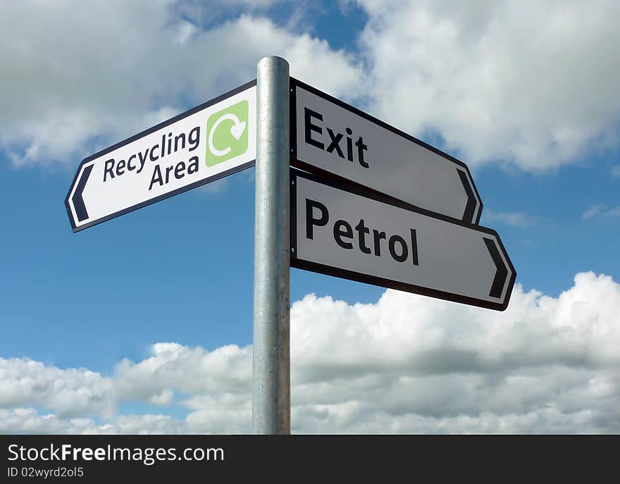 Close up of direction sign against blue cloudy sky