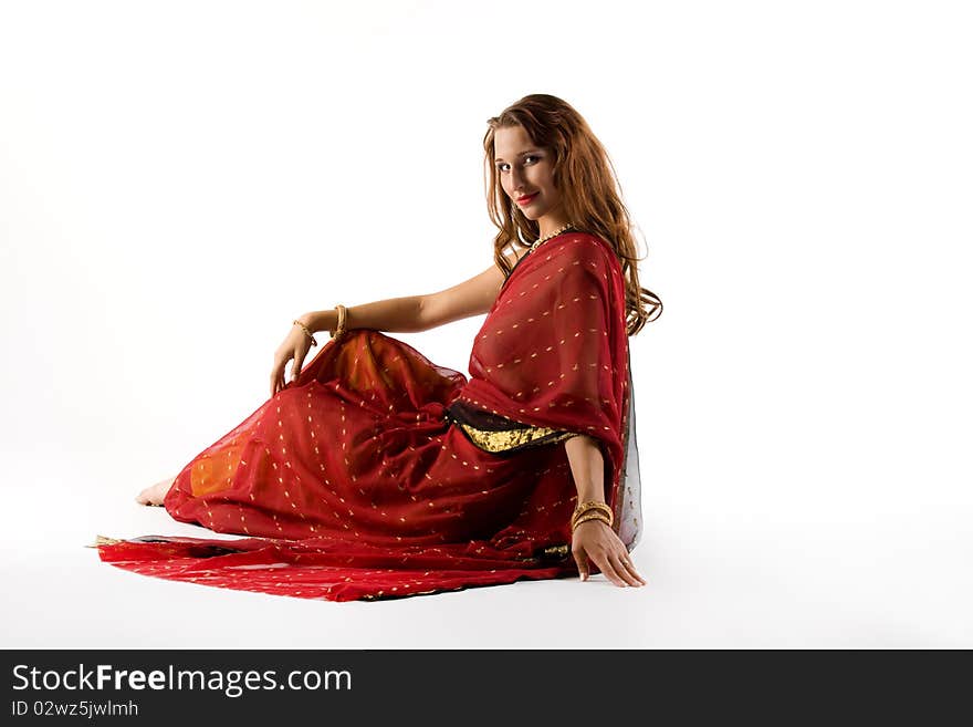 Young woman in traditional dress sit on white background