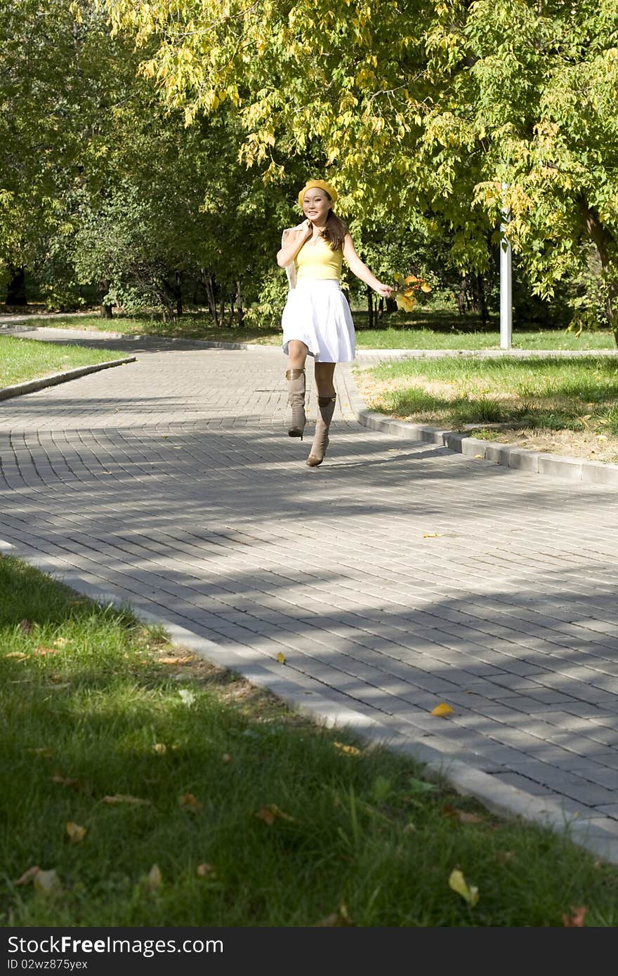 Girl walking in autumn park