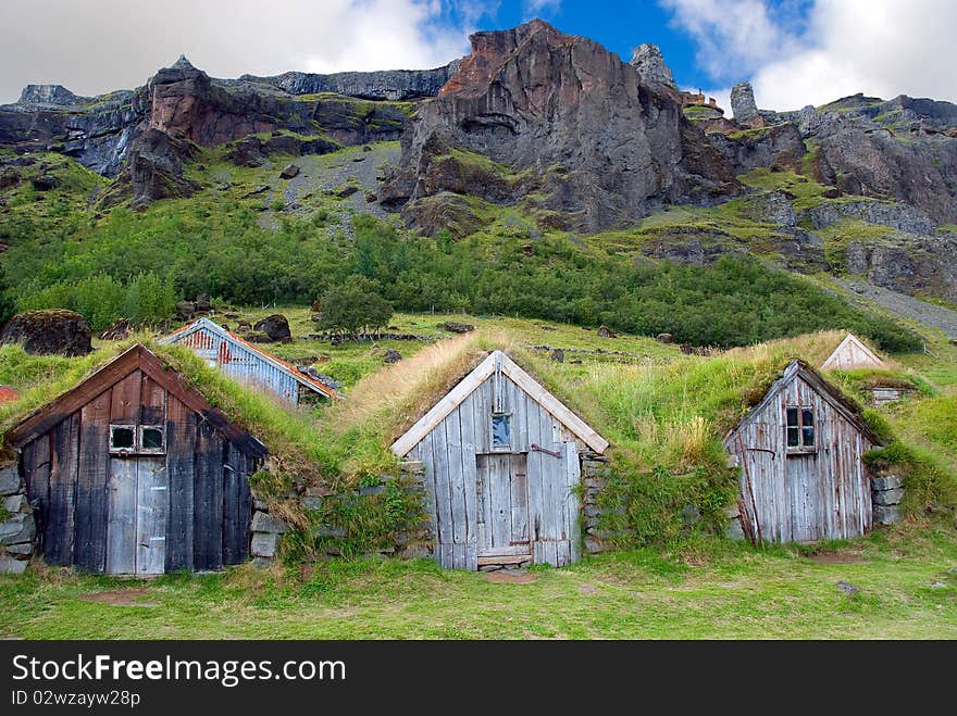 Wooden houses with roofs covered with grass. Wooden houses with roofs covered with grass