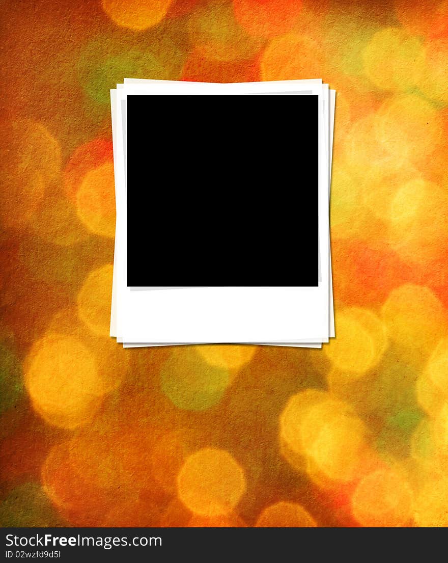 Photo frames on a paper with background lights.