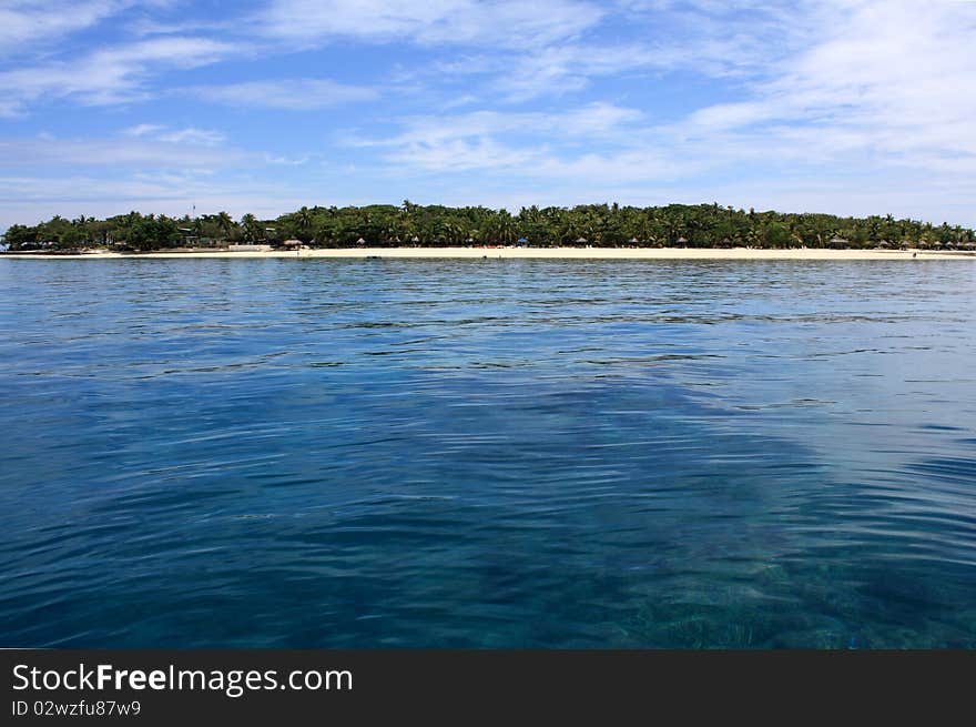 Beautiful tropical island on the horizon between sky and ocean. Beautiful tropical island on the horizon between sky and ocean