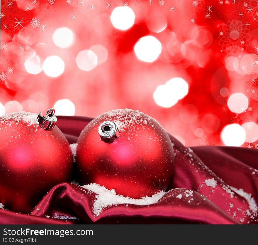 Studio photo of Christmas red glass balls in dark red soft silk with abstract background. Studio photo of Christmas red glass balls in dark red soft silk with abstract background