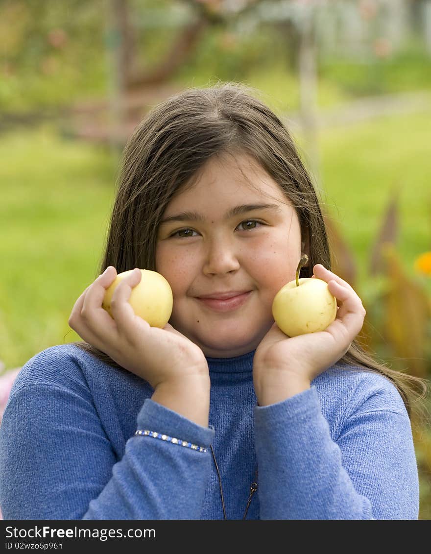 Girl holding green apples outdoor. Girl holding green apples outdoor