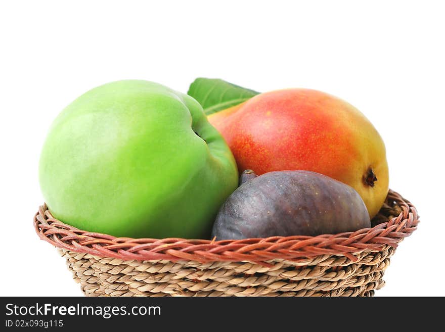 Fresh delicious fruits in the basket isolated on white. Fresh delicious fruits in the basket isolated on white