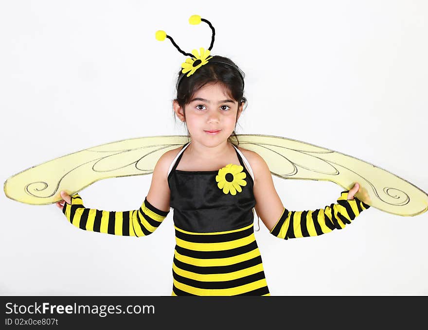 Cute Little girl wearing a bee costume on white background. Cute Little girl wearing a bee costume on white background.