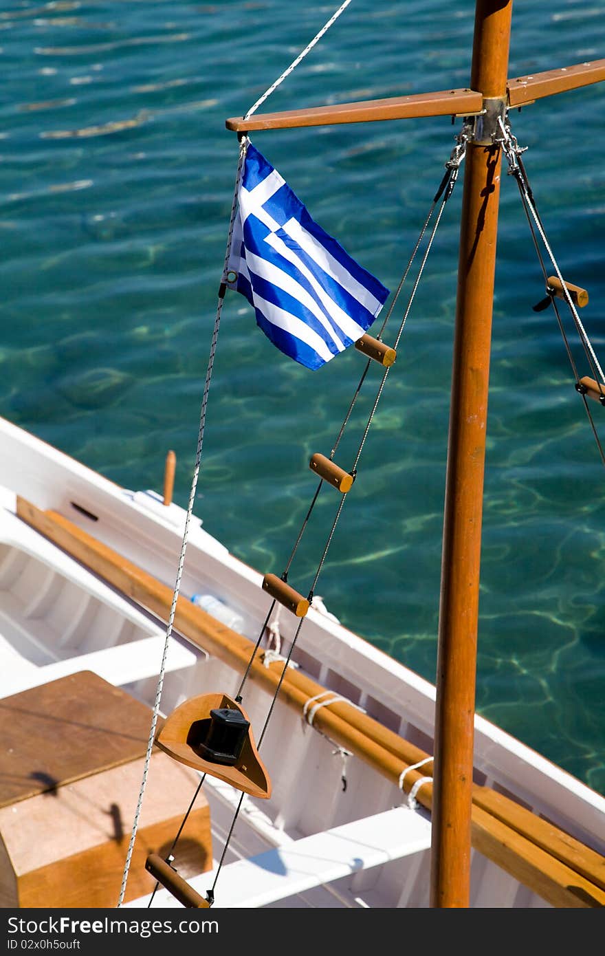 The Flag of Greece on a rowboat in the harbor of a Greek island. The Flag of Greece on a rowboat in the harbor of a Greek island.