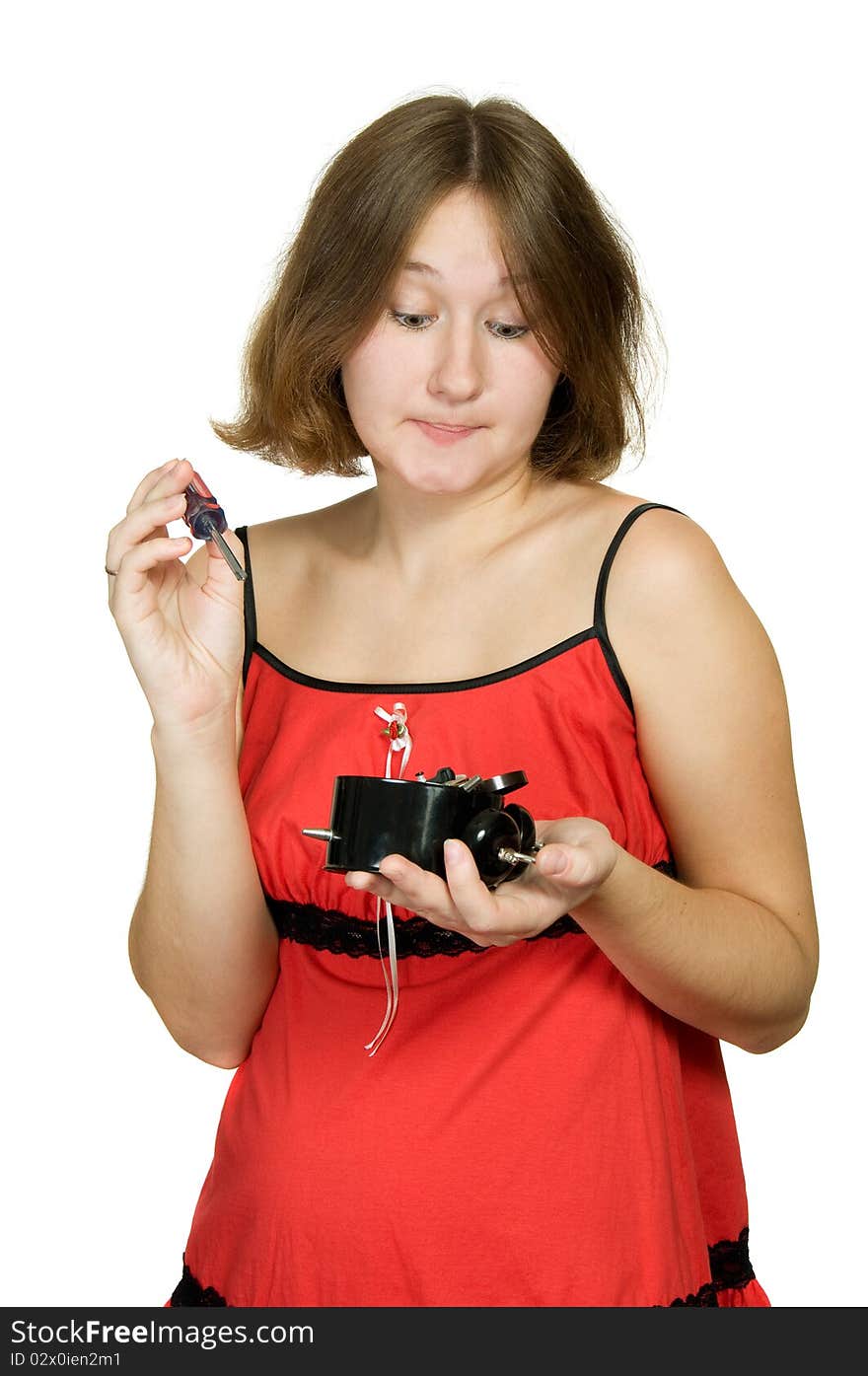 Adorable woman is trying to repair broken alarm-clock. Adorable woman is trying to repair broken alarm-clock