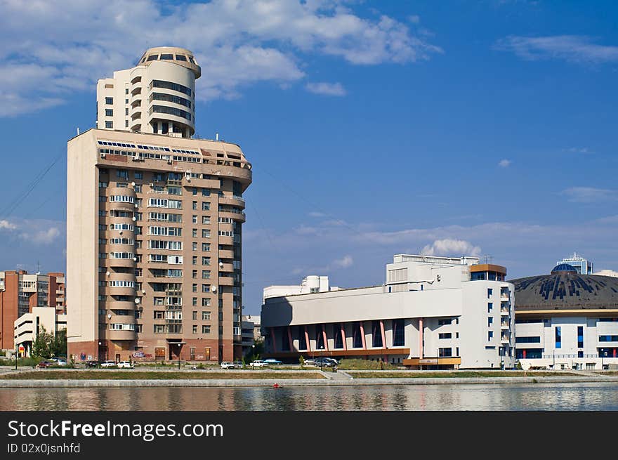 Modern city view with the river in front shot in bright sunlight