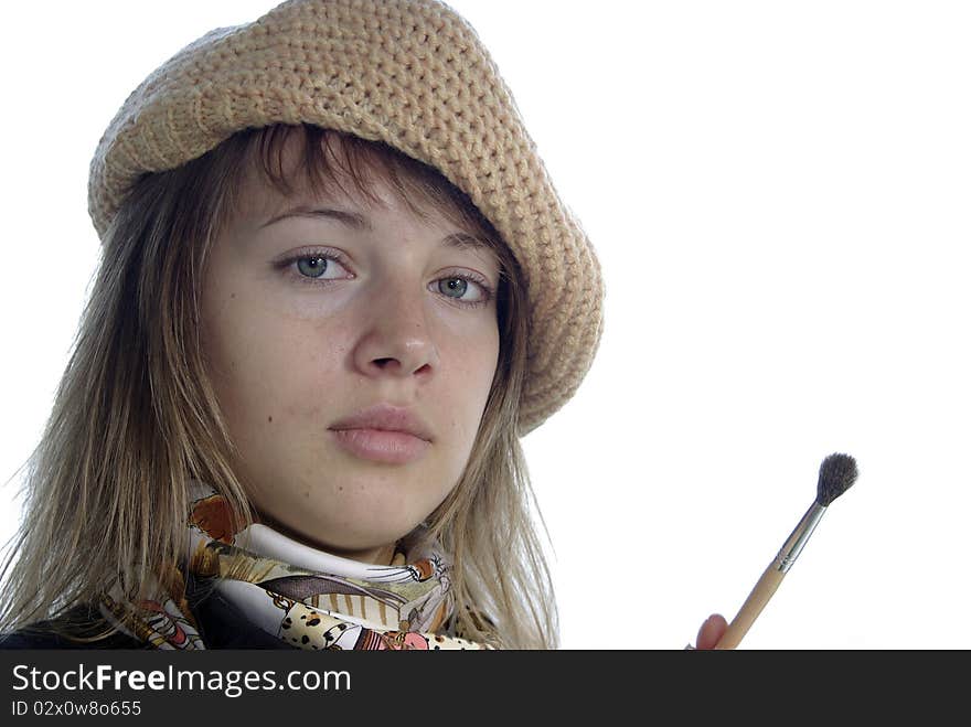 Lady artist in berret with brush on white close up. Lady artist in berret with brush on white close up