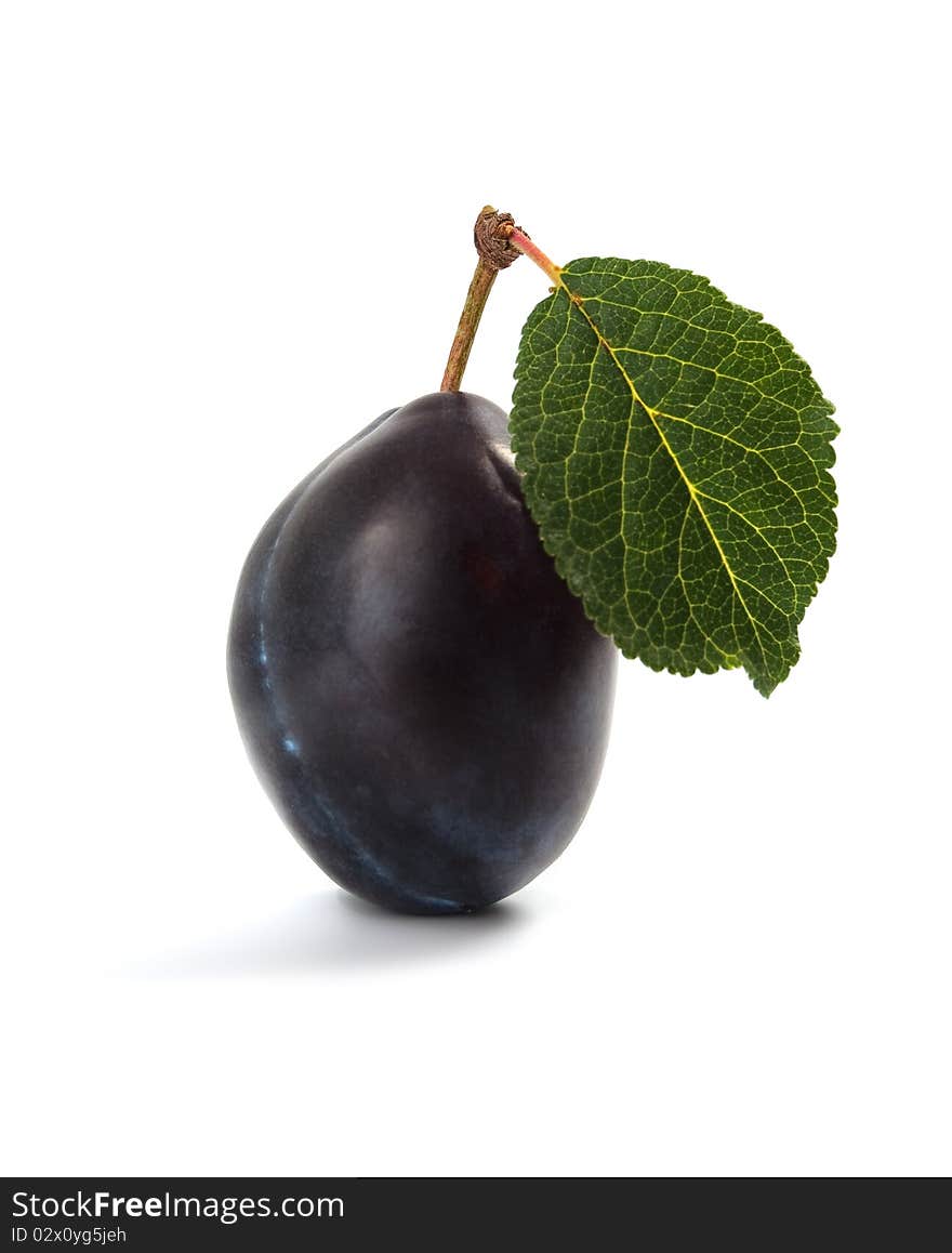 Juicy plum with green leaf on white background. Juicy plum with green leaf on white background