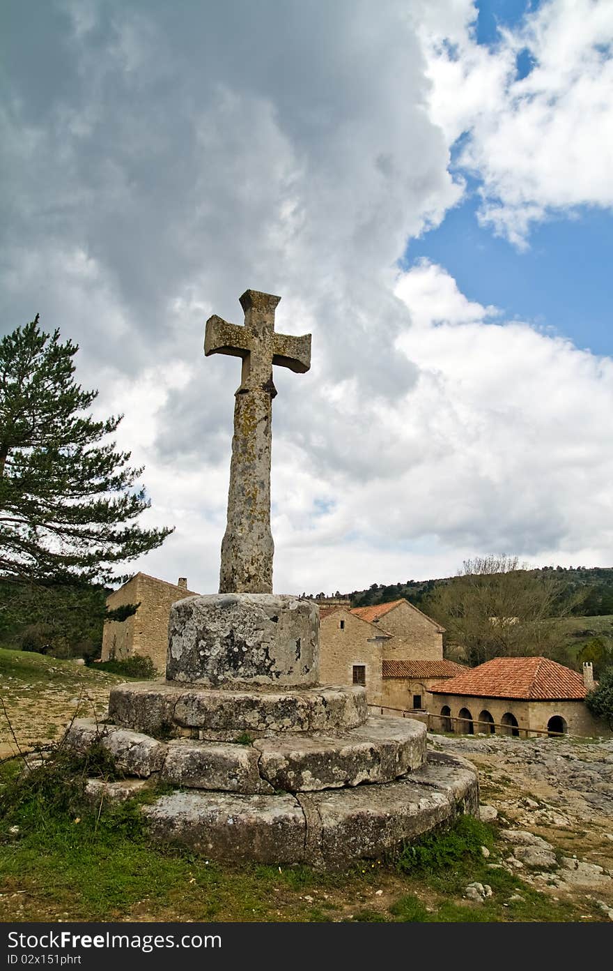 Old stone cross in town of Spain