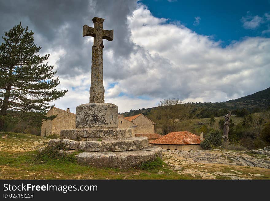 Old stone cross in town of Spain