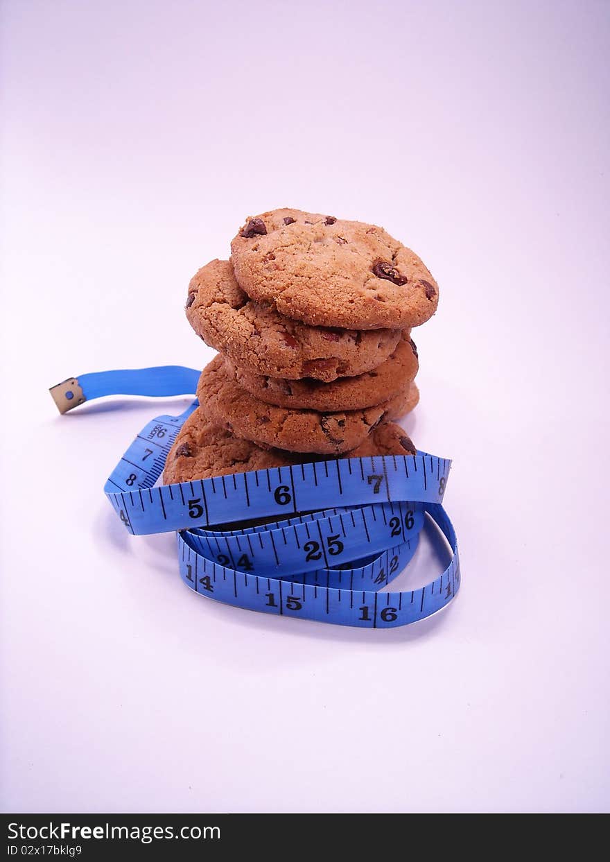 Chocolate chip cookies wrapped with a measuring tape. Chocolate chip cookies wrapped with a measuring tape