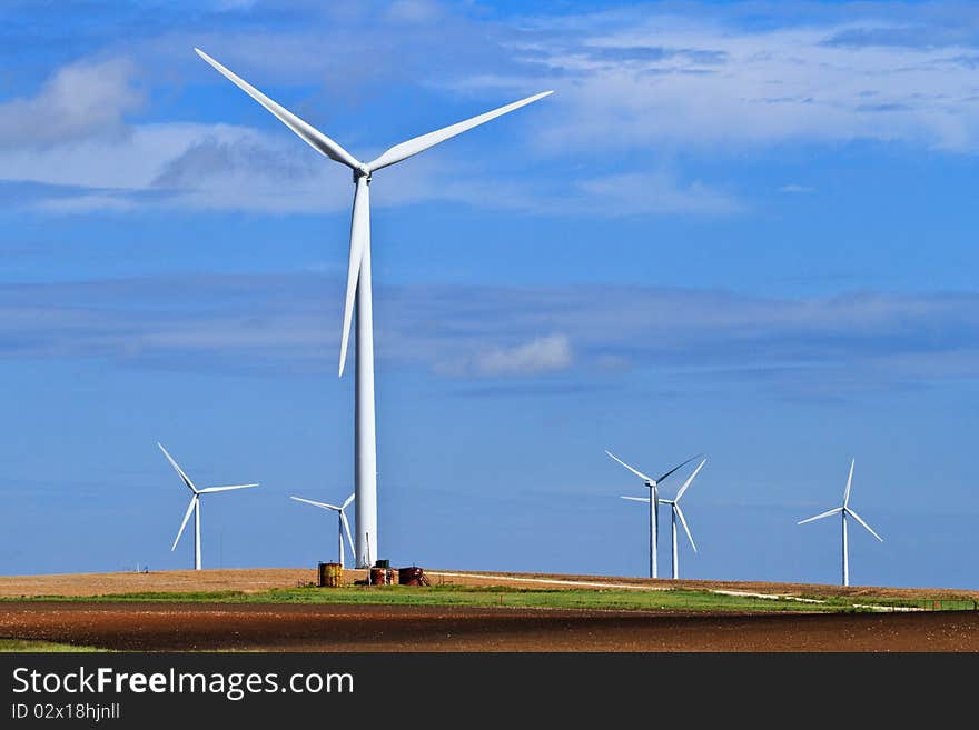 Blue skies, white wind generators and farm land. Blue skies, white wind generators and farm land.