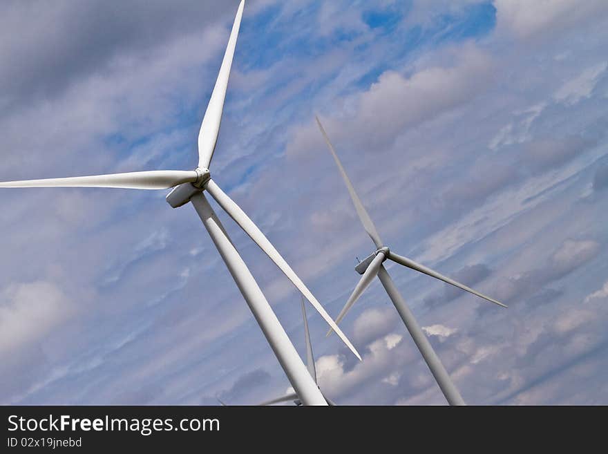 Dutch angle of two wind generators and horizontal bands of clouds. Dutch angle of two wind generators and horizontal bands of clouds