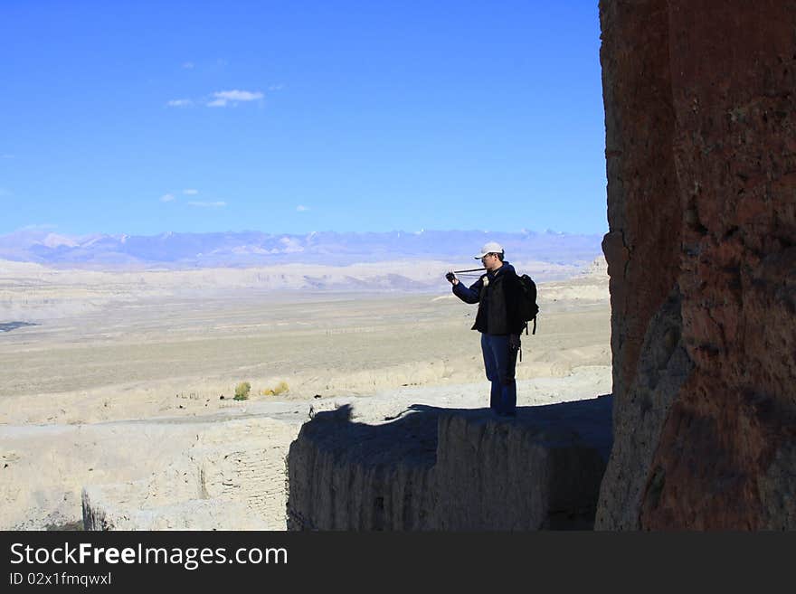 A photographer is looking into view finder, Tibet, China. A photographer is looking into view finder, Tibet, China