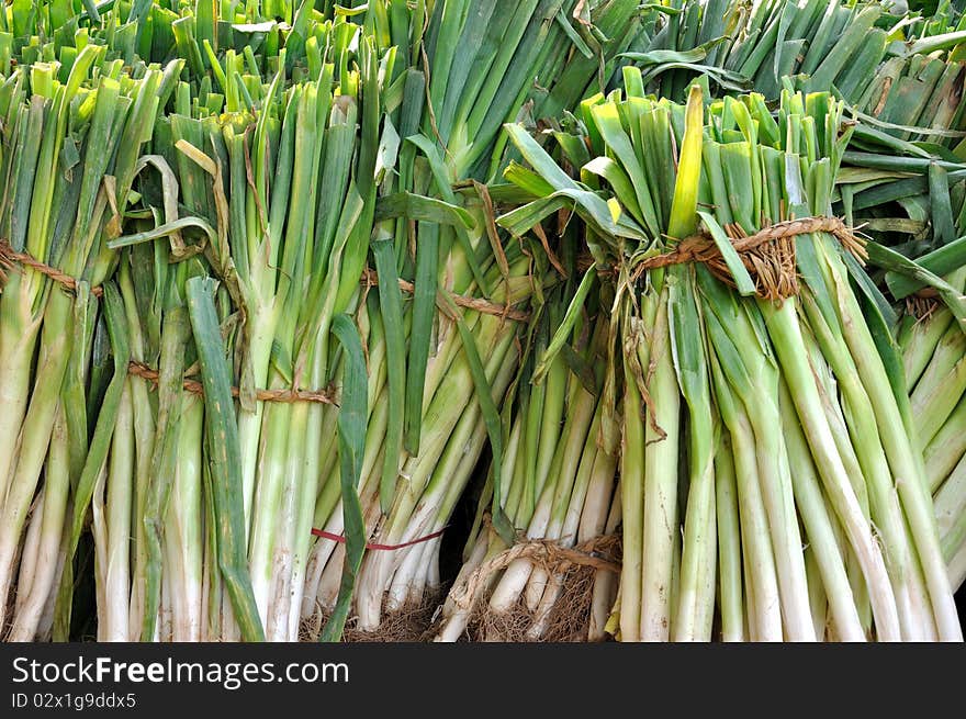 Raw shallot in bundle stacking for sell in super market, shown as original and fresh vegetable which is not disposed.