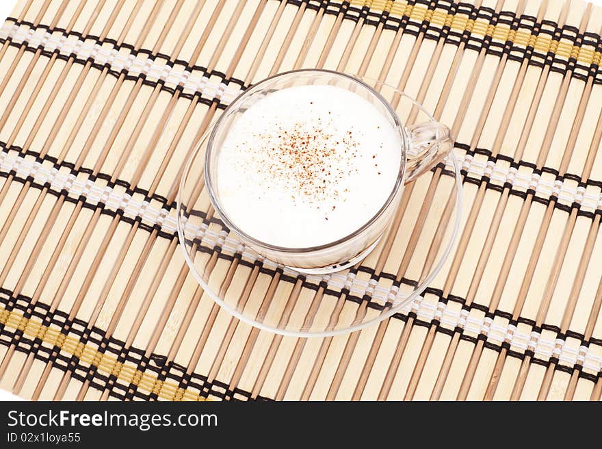 Cappuccino cup on bamboo mat