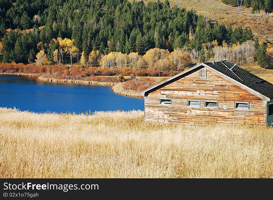 Cabin by a blue lake in the forest. Cabin by a blue lake in the forest