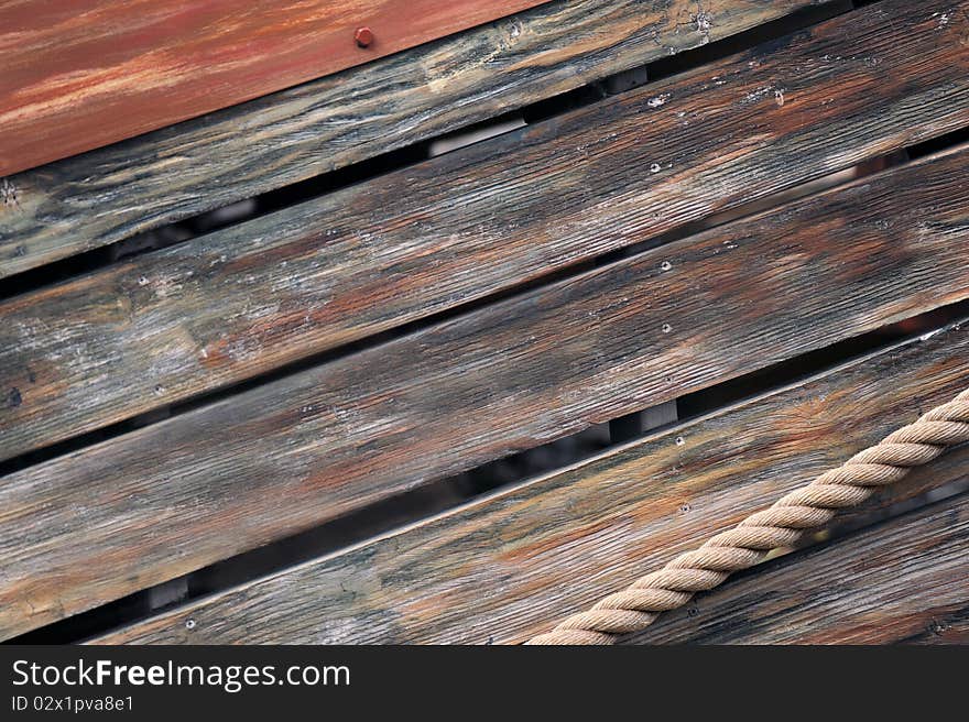 Wood background, ship and rope