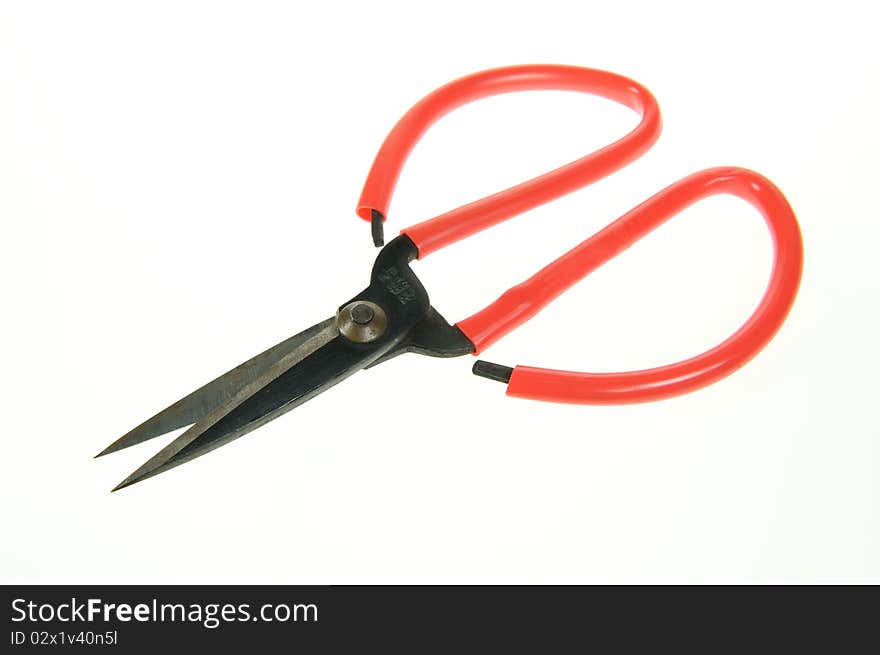 A red scissors on a white background