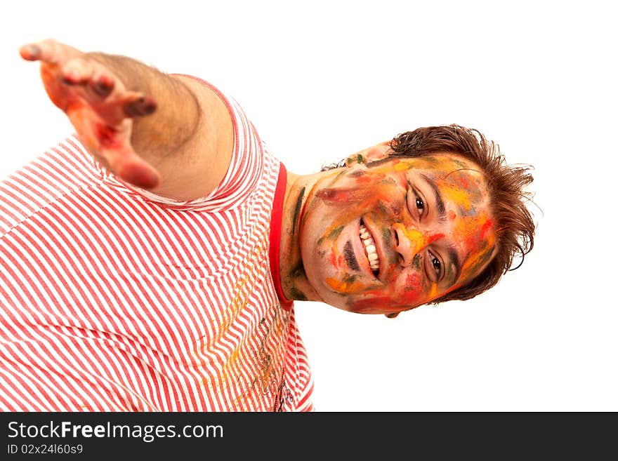 A young Indian guy having fun in Holi festival.