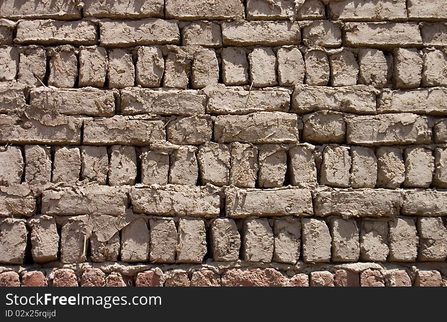 Wall from clay bricks as a background close up