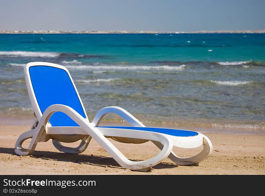 Dark blue chaise lounge at the sea