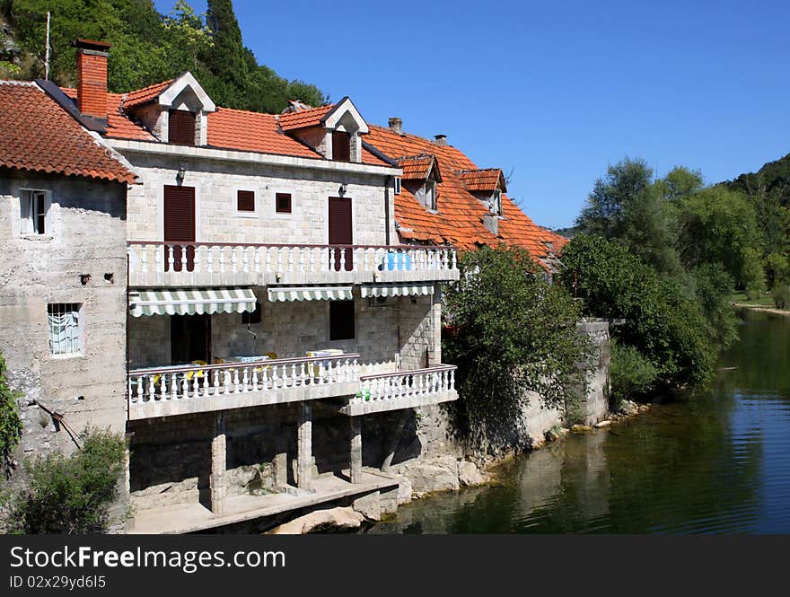 Detail of old houses on a river bank in village Rijeka Crnojevica - Lake Skadar, Montenegro. Detail of old houses on a river bank in village Rijeka Crnojevica - Lake Skadar, Montenegro