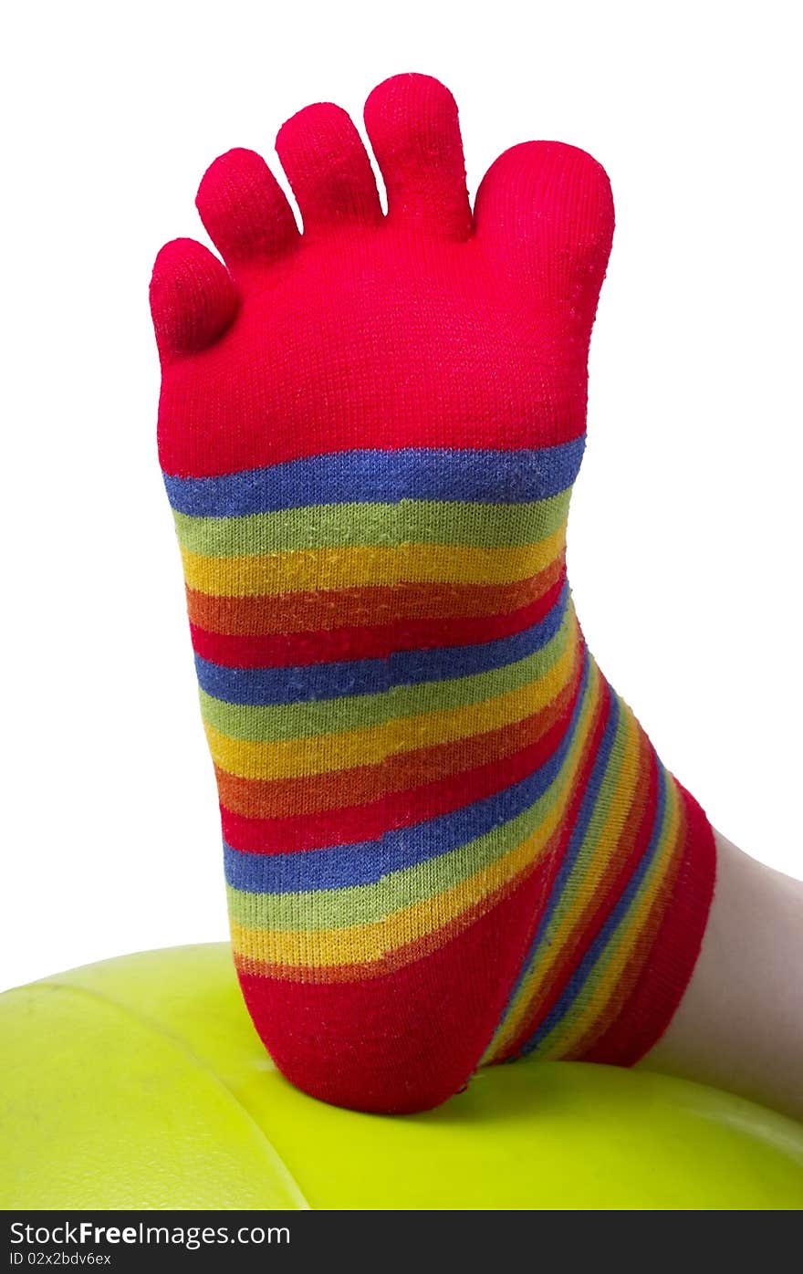 One foot in funny colorful stocking (macro shot). One foot in funny colorful stocking (macro shot)