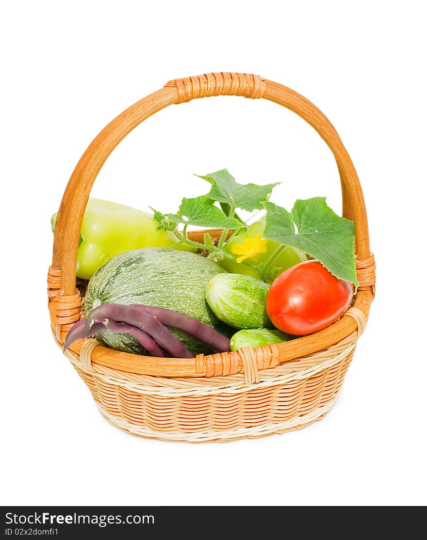 Wattled basket with vegetables isolated on white