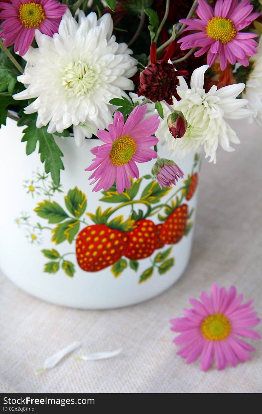 Wild flowers in a vase on a wooden table. Wild flowers in a vase on a wooden table