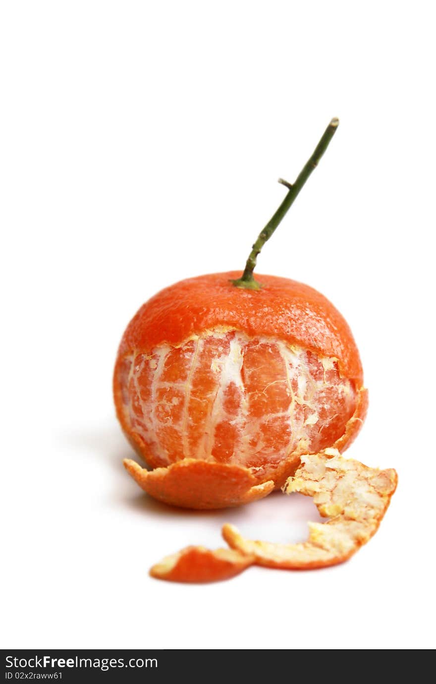 Seedless tangerine (clementine) partly peeled and shot on white background. Seedless tangerine (clementine) partly peeled and shot on white background