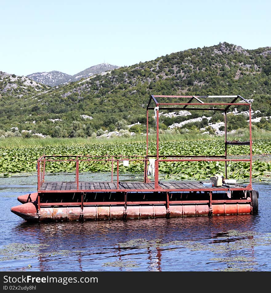 Strange old metal boat moored in the middle of lake Skadar