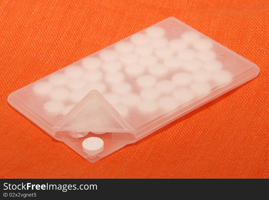 White pills in special plastic container with cover up. White pills in special plastic container with cover up.