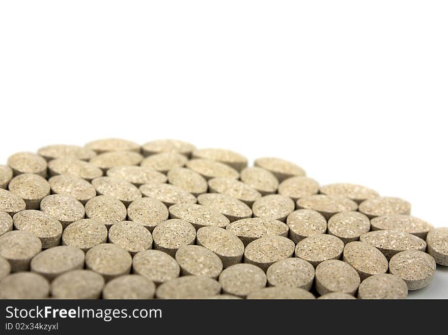 Heap of grassy tablets on a white background it is isolated