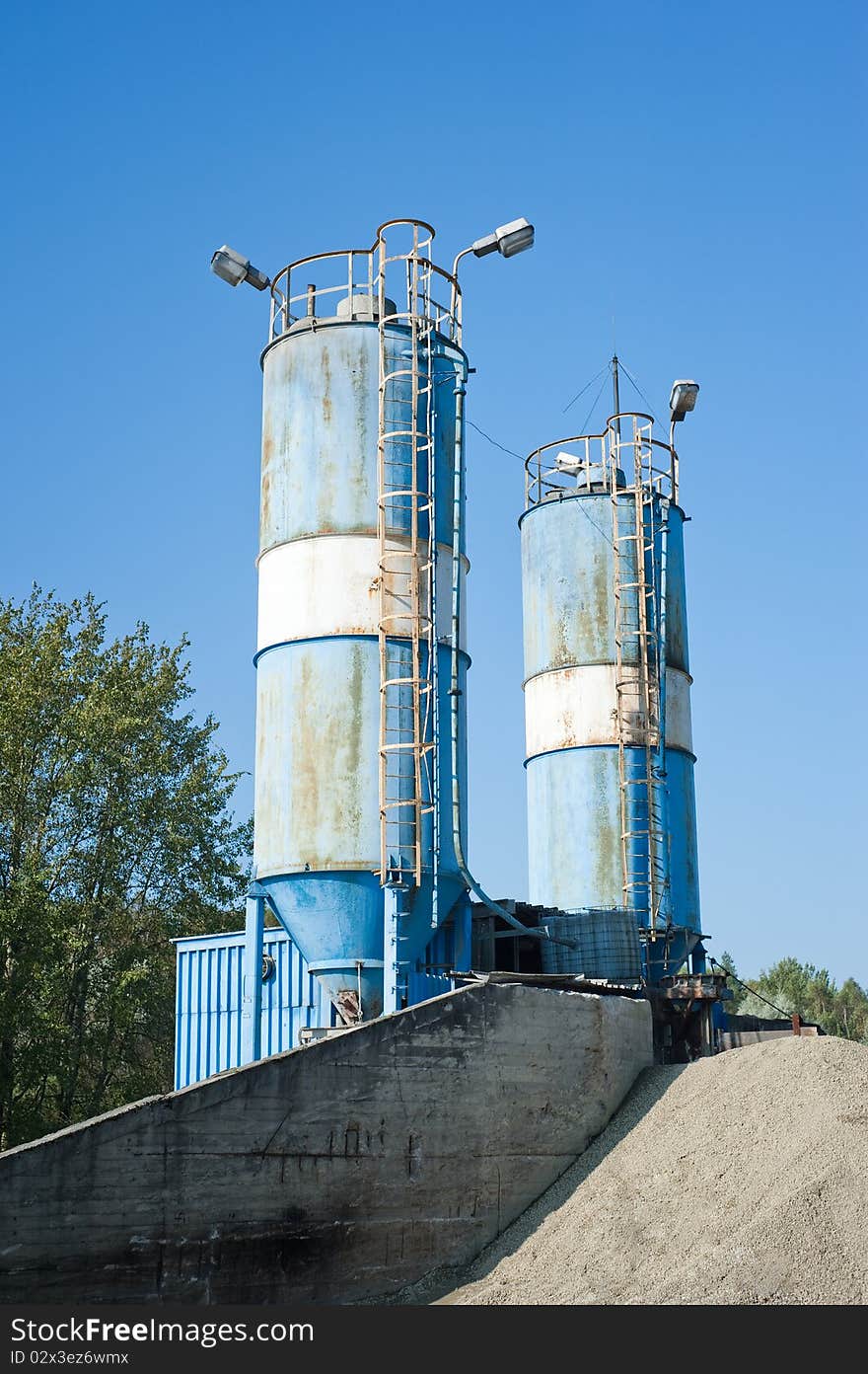 Photo of blue cement silos in the cement factory