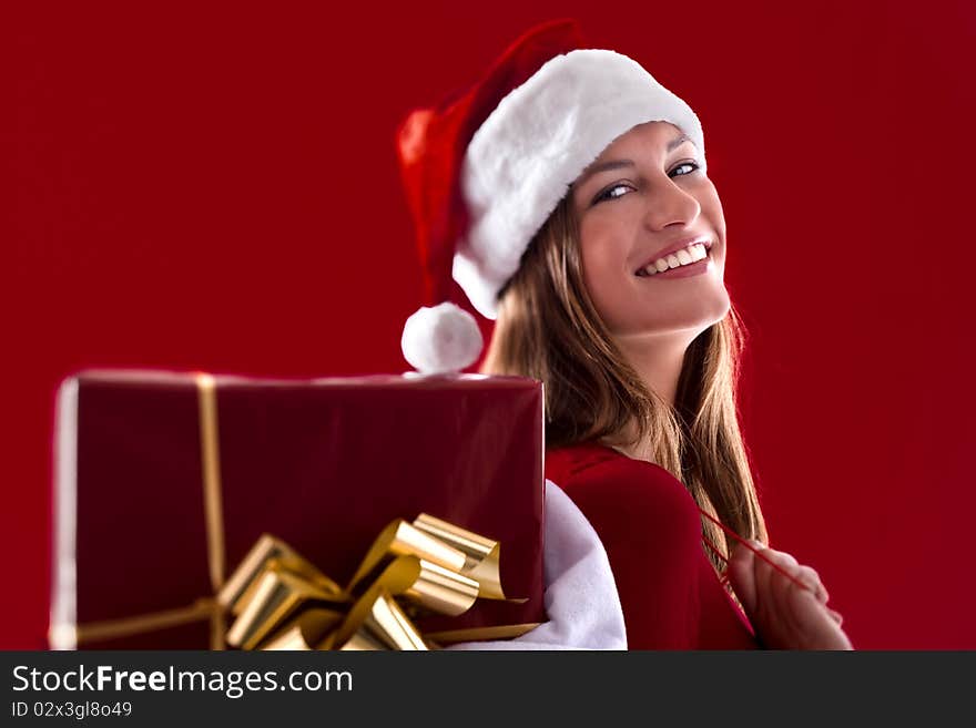 Smiling Santa Girl with gifts on red background