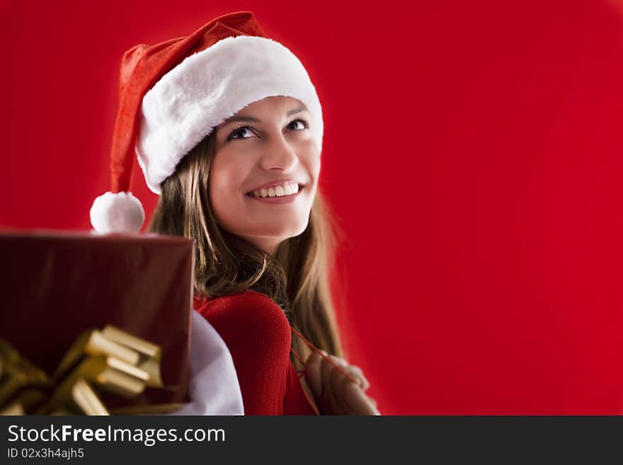 Smiling Santa Girl with gifts on red background