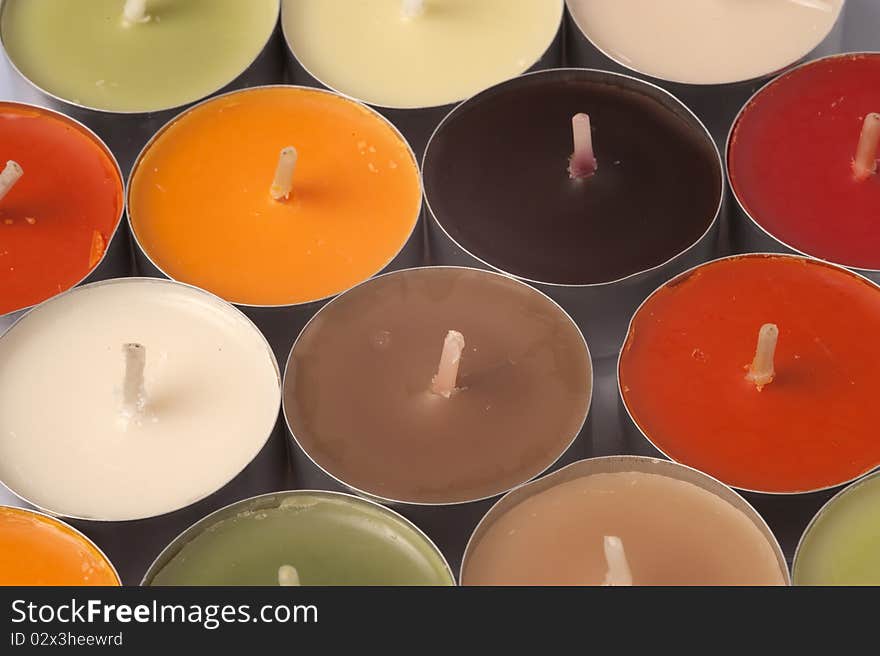 Various color candles on a white background