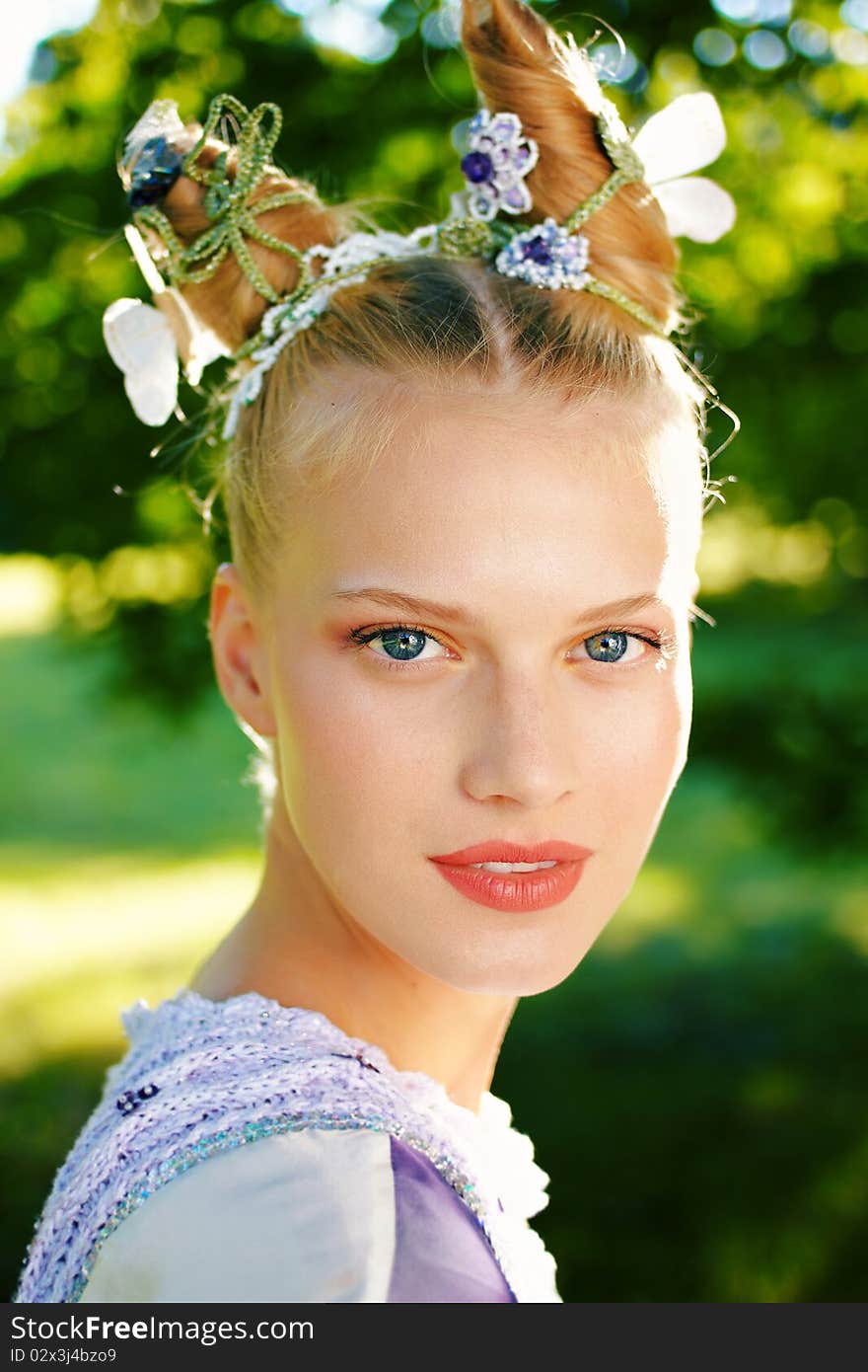 Beauty outdoor portrait with defocused forest background