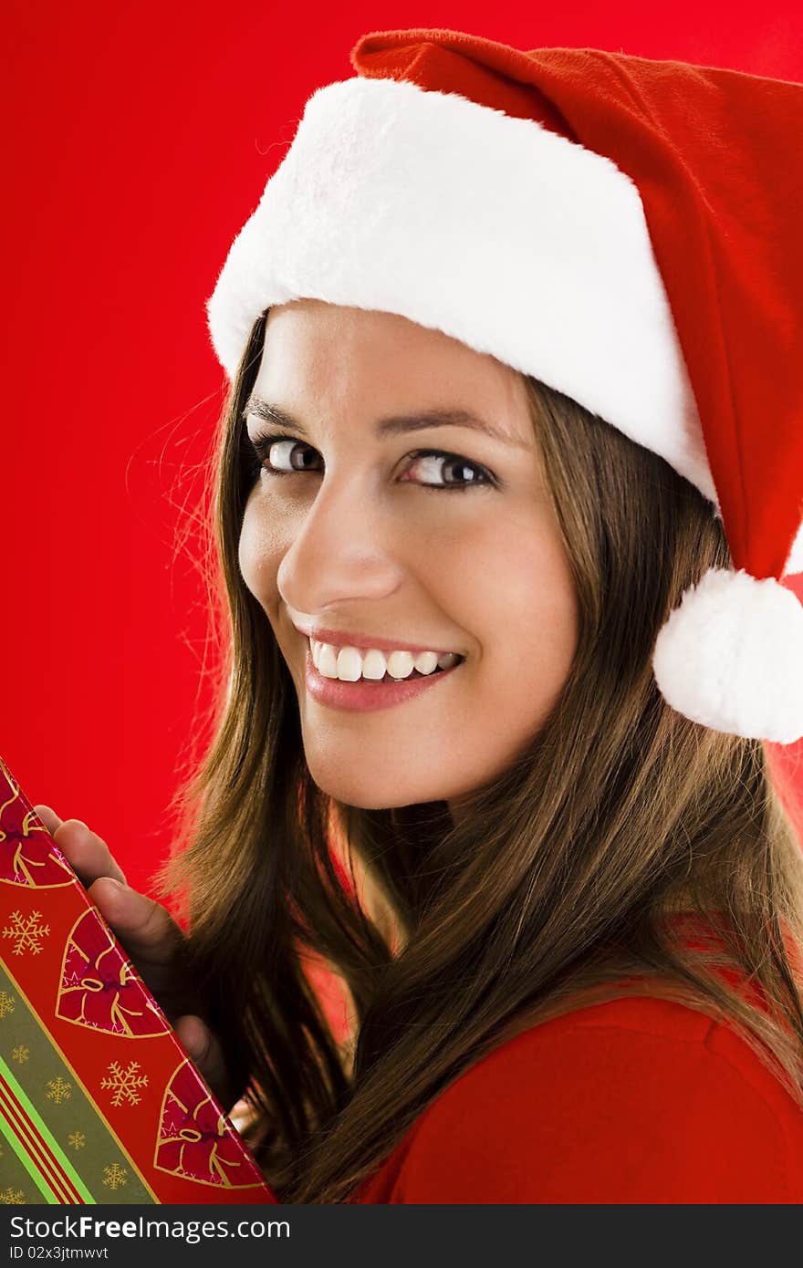 Portrait of a smiling Santa Girl with present