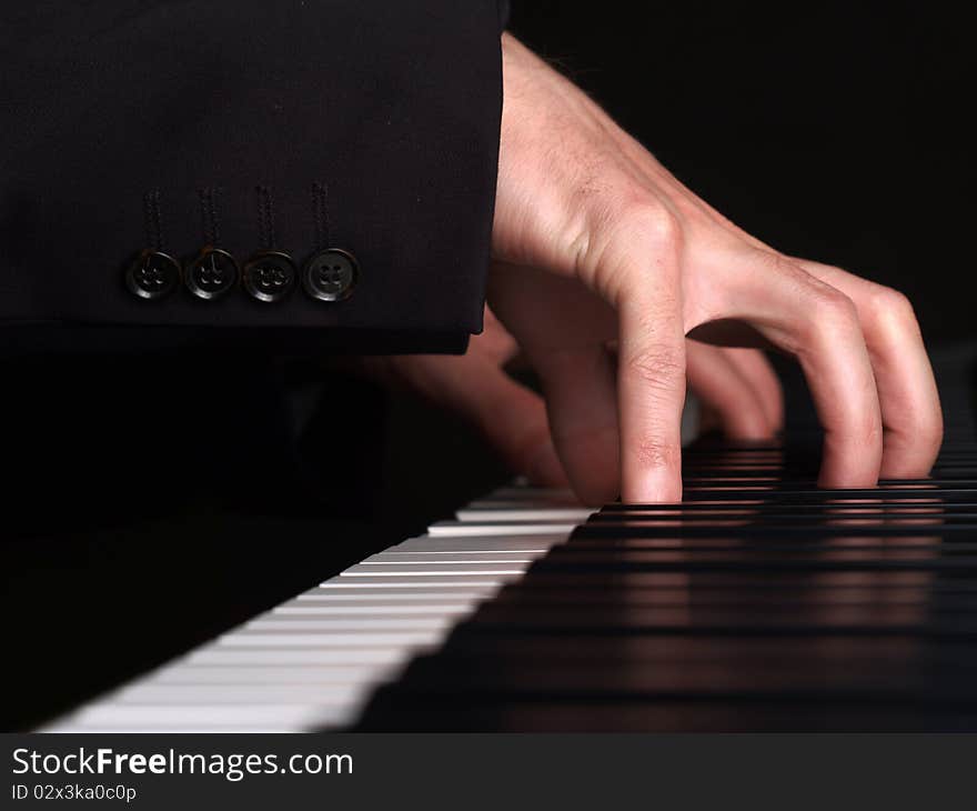 A pianist plays a concert. View on his fingers