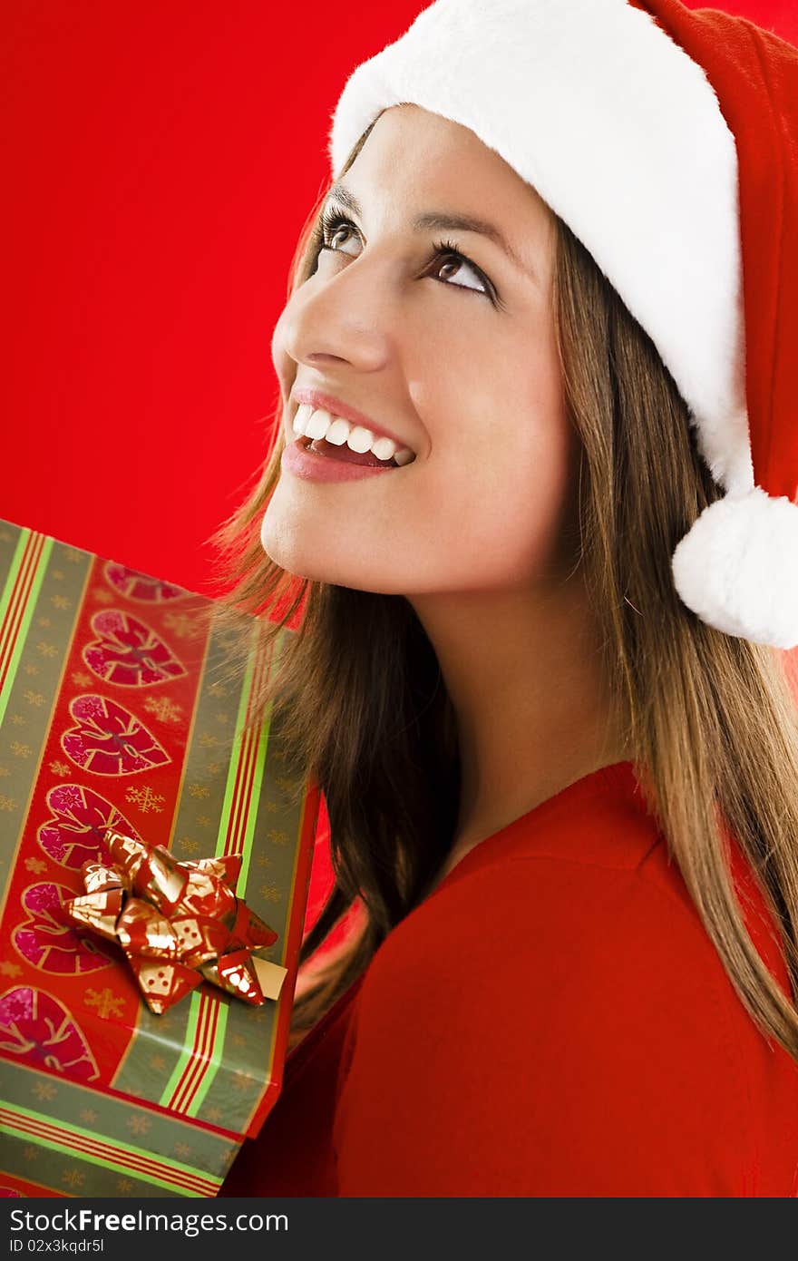 Portrait of a smiling Santa Girl with present